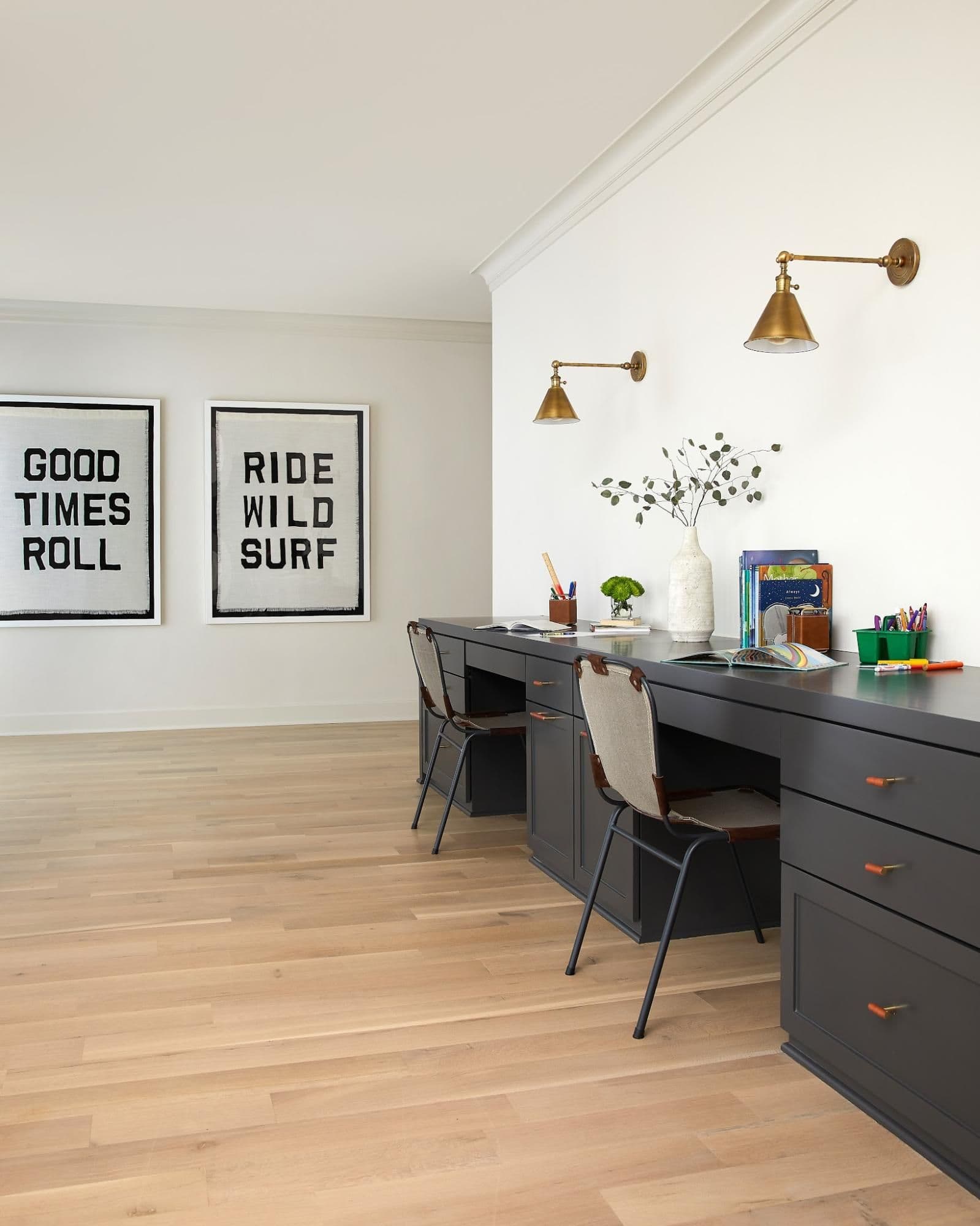 Built-in homework desk below "Ride Wild Surf" artwork with brass sconces
